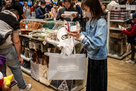 Tokyo, Japan, October 29, 2023: Shopper examining merchandise in a Nintendo storeのeditorial素材