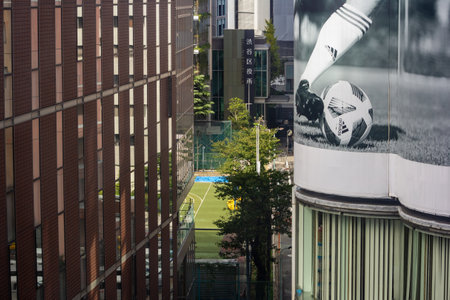 Tokyo, Japan, October 29, 2023: Soccer field in urban Tokyo with surrounding billboardsのeditorial素材