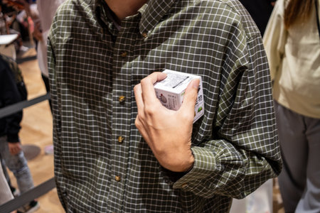 Tokyo, Japan, October 29, 2023: Man holding a Nintendo gaming product in storeのeditorial素材