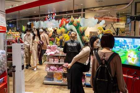 Tokyo, Japan, October 29, 2023: Shoppers in a Nintendo store with a vibrant Pokemon display in the backgroundのeditorial素材