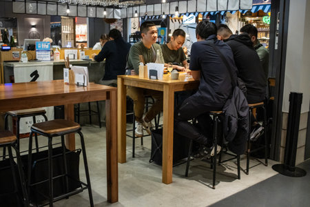 Tokyo, Japan, October 29, 2023: Customers enjoying meals at a casual dining area in a food courtのeditorial素材