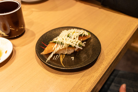 Tokyo, Japan, October 29, 2023: A plate of sushi topped with mayonnaise at a Japanese restaurantのeditorial素材