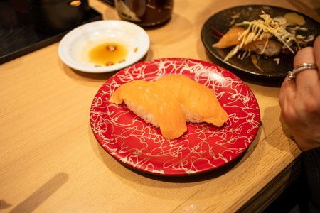 Tokyo, Japan, October 29, 2023: Salmon nigiri sushi on a decorative plate at a sushi barのeditorial素材