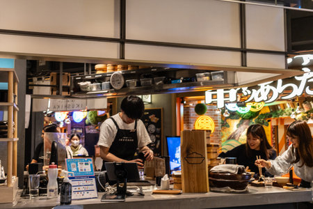 Tokyo, Japan, October 29, 2023: Customers enjoying a meal at a cozy Tokyo ramen shopのeditorial素材