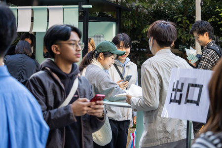 Tokyo, Japan, October 29, 2023: Queue of people using smartphonesのeditorial素材