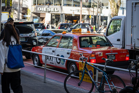 Tokyo, Japan, October 29, 2023: Busy taxi scene in front of a DIESEL store in Tokyoのeditorial素材
