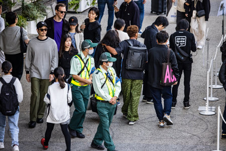 Tokyo, Japan, October 29, 2023: Crowd of pedestrians with security personnelのeditorial素材