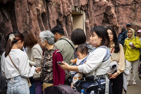 Tokyo, Japan, October 31, 2023: People gathered in front of a zoo exhibit, possibly watching animalsのeditorial素材