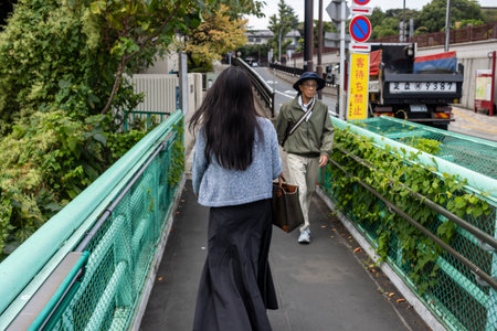 Tokyo, Japan, October 31, 2023: People crossing a pedestrian overpass in Tokyoのeditorial素材