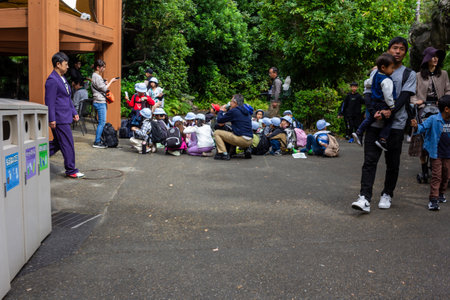 Tokyo, Japan, October 31, 2023: Group of students on a break during a school trip at a parkのeditorial素材