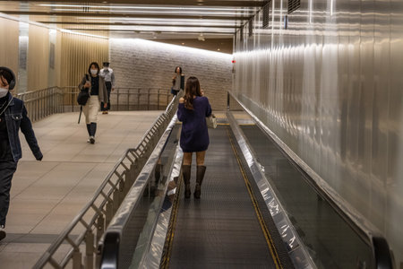 Tokyo, Japan, October 31, 2023: People using an escalator in a modern subway stationのeditorial素材