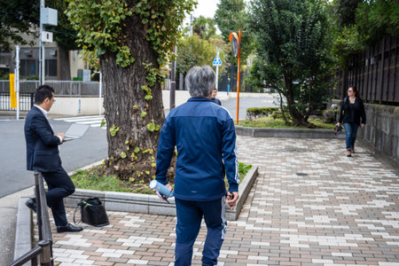 Tokyo, Japan, October 31, 2023: People walking on a city sidewalk in a residential areaのeditorial素材