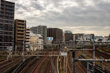 Tokyo, Japan, October 31, 2023: Train tracks with multiple rails and urban buildings in backgroundのeditorial素材