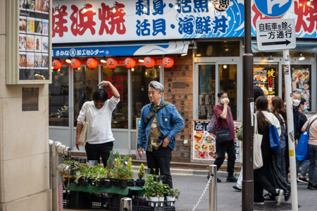 Tokyo, Japan, October 31, 2023: Locals and tourists shopping at a busy market streetのeditorial素材