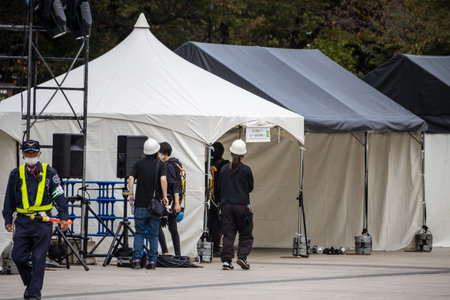 Tokyo, Japan, October 31, 2023: Film crew setting up for a shoot with equipment tents in an urban areaのeditorial素材