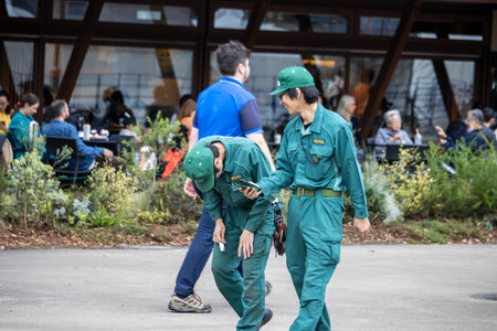 Tokyo, Japan, October 31, 2023: Zoo workers in uniform having a conversation in the parkのeditorial素材