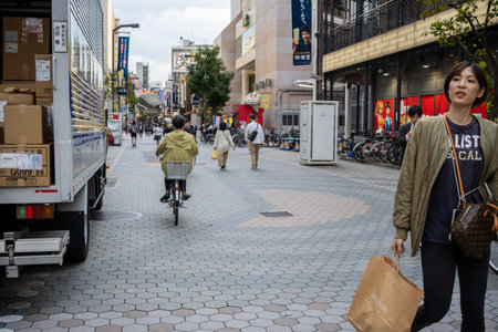 Tokyo, Japan, October 31, 2023: Pedestrians and cyclists sharing the path in a busy Tokyo streetのeditorial素材