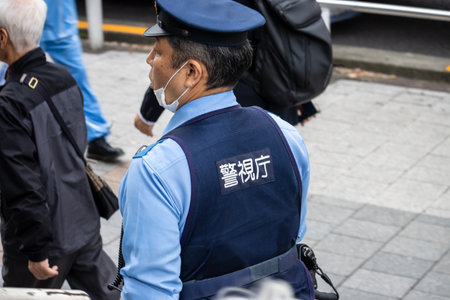 Tokyo, Japan, October 31, 2023: Police officer on duty in the cityのeditorial素材