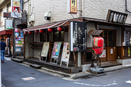 Tokyo, Japan, November 1, 2023: Quaint restaurant entrance with red lanterns and menu displayのeditorial素材
