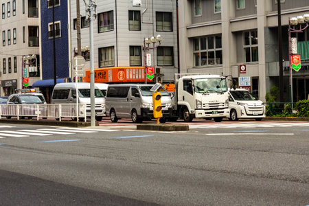 Tokyo, Japan, October 31, 2023: Trucks and vehicles on a city road with traffic signsのeditorial素材