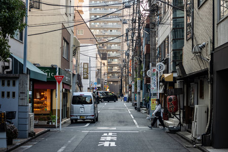 Tokyo, Japan, November 1, 2023: Quiet alleyway in Tokyo with local shops and pedestriansのeditorial素材