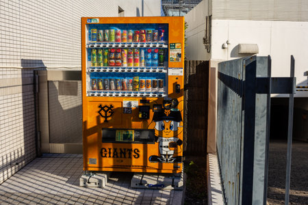 Tokyo, Japan, November 1, 2023: Vending machine with sports team branding on a Tokyo streetのeditorial素材