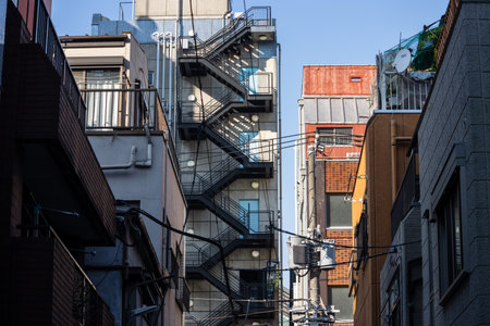 Tokyo, Japan, November 1, 2023: View of narrow alley with residential buildings and external staircasesのeditorial素材