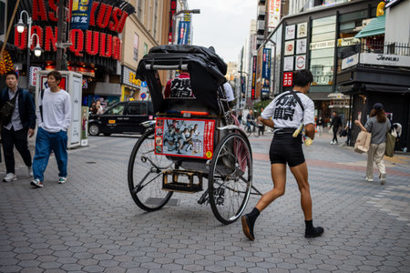 Tokyo, Japan, October 31, 2023: Rickshaw runner in traditional attraction on the streets of Tokyoのeditorial素材