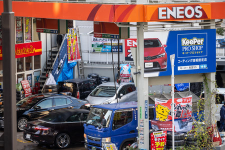 Tokyo, Japan, November 1, 2023: Busy gas station in Tokyo with colorful branding and advertisementsのeditorial素材