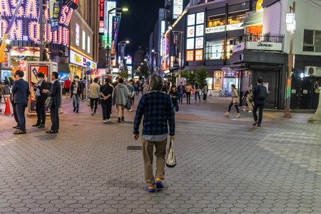 Tokyo, Japan, November 1, 2023: Vibrant nightlife scene with pedestrians in Tokyo's entertainment districtのeditorial素材