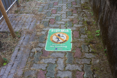 Tokyo, Japan, November 1, 2023: 'No Smoking' sign on the pavement in a Tokyo parkのeditorial素材