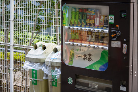 Tokyo, Japan, November 1, 2023: Recycle Bins and Vending Machine in a Secured Outdoor Areaのeditorial素材