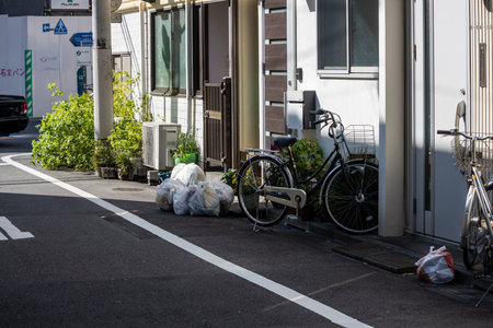 Tokyo, Japan, November 1, 2023: Sidewalk in Tokyo with Bicycles and Recycle Binsのeditorial素材