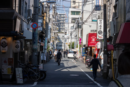 Tokyo, Japan, November 1, 2023: Bustling Alley with Shops and Pedestriansのeditorial素材