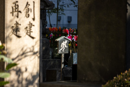 Tokyo, Japan, November 1, 2023: Shrine Entrance with Traditional Lantern and Floral Offeringsのeditorial素材