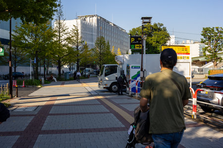 Tokyo, Japan, November 1, 2023: Pedestrian Walkway in Tokyo with People and Vending Machines