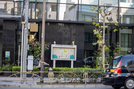 Tokyo, Japan, November 1, 2023: Urban Street Scene with Information Sign and Cyclistのeditorial素材