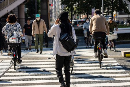 Tokyo, Japan, November 1, 2023: Pedestrians and Cyclists Crossing at a Busy Intersectionのeditorial素材