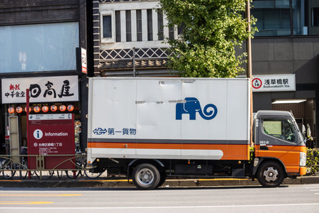 Tokyo, Japan, November 1, 2023: Delivery Truck on Urban Street with Advertisement