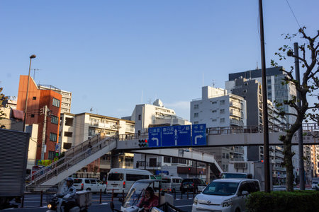 Tokyo, Japan, November 1, 2023: Pedestrian overpass in a busy urban district with trafficのeditorial素材