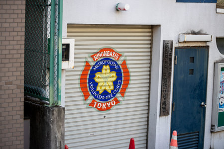 Tokyo, Japan, November 1, 2023: Closed shop with a colorful fire department emblem on the shutterのeditorial素材
