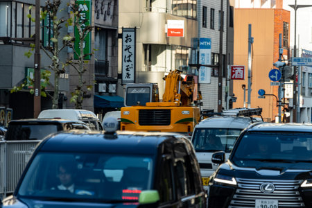 Tokyo, Japan, November 1, 2023: Construction work in Tokyo with heavy machinery among urban trafficのeditorial素材
