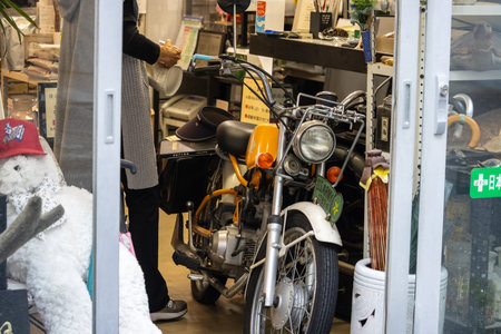 Tokyo, Japan, November 1, 2023: Motorcycle Repair Shop with Various Bikes and Partsのeditorial素材