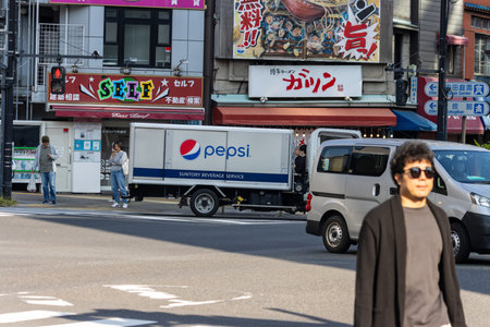Tokyo, Japan, November 1, 2023: Urban Street with Pepsi Delivery Truck and Colorful Signageのeditorial素材
