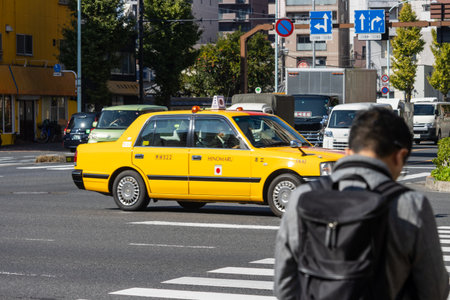 Tokyo, Japan, November 1, 2023: Iconic Yellow Taxi on Tokyo Streetsのeditorial素材