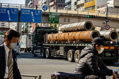 Tokyo, Japan, November 1, 2023: Truck Carrying Large Pipes on Tokyo Streetのeditorial素材