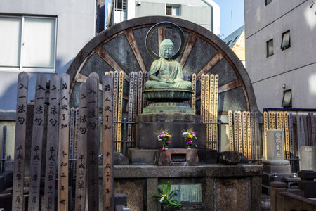 Tokyo, Japan, November 1, 2023: Buddha Statue with Wooden Prayer Plaquesのeditorial素材