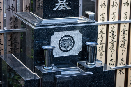 Tokyo, Japan, November 1, 2023: Traditional Japanese Cemetery with Family Crestsのeditorial素材