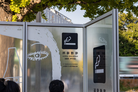 Tokyo, Japan, November 1, 2023: Designated Smoking Area with Creative Visuals in Public Spaceのeditorial素材