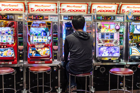Tokyo, Japan, November 1, 2023: Person Playing Pachinko in a Japanese Arcadeのeditorial素材